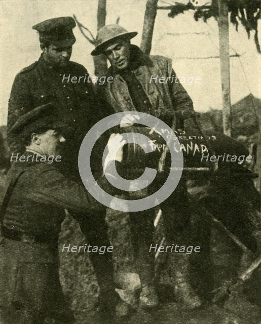 Soldiers write Christmas greetings on a shell, Western Front, First World War, c1916, (c1920). Creator: Unknown.
