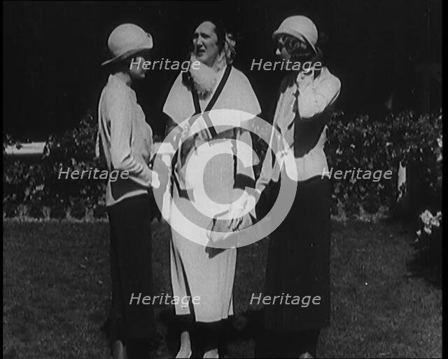 A Group of Three Female Civilians Wearing Fashionable Clothes Standing in a Garden, 1929. Creator: British Pathe Ltd.