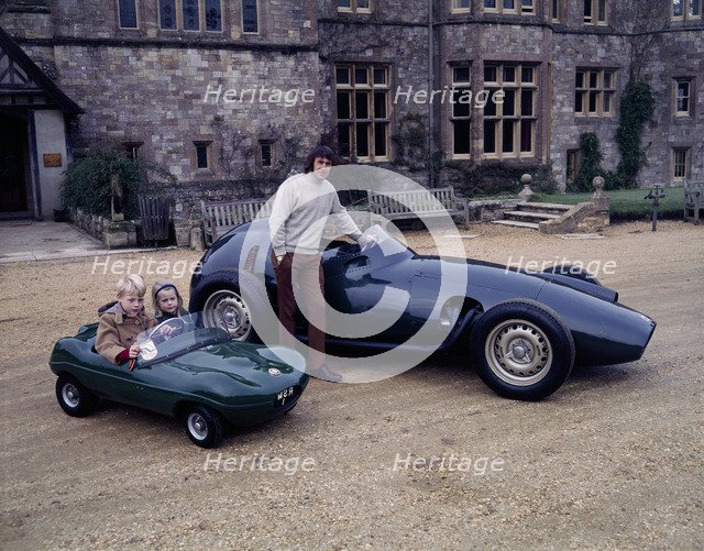 Jackie Stewart posing with a 1957 BRM. Artist: Unknown