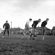 Children walking on stilts, c1955. Creator: Arthur Charles Kirby Ware.
