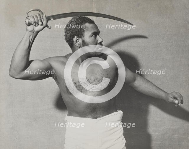 Rex Ingram, shirtless, with cutlass, 1938. Creator: Unknown.