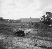 Home in a district from which many families immigrate West, near Sallisaw, Oklahoma, 1938. Creator: Dorothea Lange.