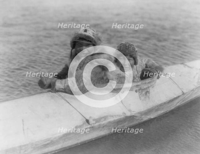 Boys in a kaiak (i.e., kayak)-Nunivak, c1929. Creator: Edward Sheriff Curtis.