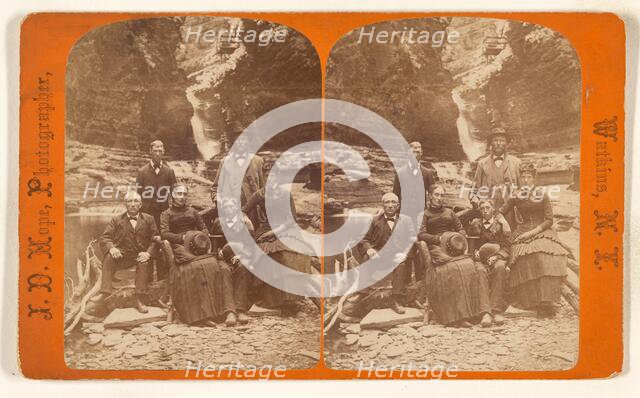 Family group portrait, posed in natural setting on rocks, 1868-1878. Creator: James Douglas Hope.