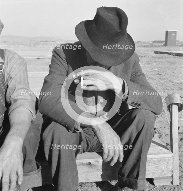 Was Nebraska farmer, now migrant farm worker in the West, Merrill, Klamath County, Oregon, 1939. Creator: Dorothea Lange.
