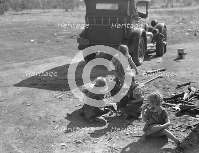 Children of migrant Oklahoma family, now living near Fresno, California, picking cotton, 1936. Creator: Dorothea Lange.