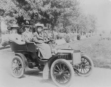 Frances Benjamin Johnston seated with three other people in automobile, between 1890 and 1910. Creator: Unknown.