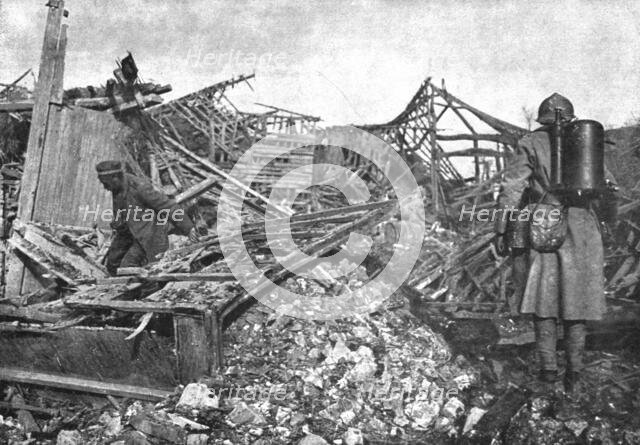 'Dans Cantigny; un des derniers Allemands trouves dans les caves du village se degage..., 1918. Creator: Unknown.