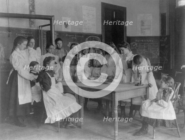 Girls posed in home economics class, 1st Division, Washington, D.C., (1899?). Creator: Frances Benjamin Johnston.