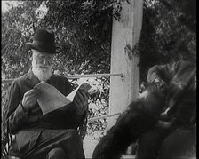 George Bernard Shaw and a Male Civilian Sitting in a Garden, 1920s. Creator: British Pathe Ltd.