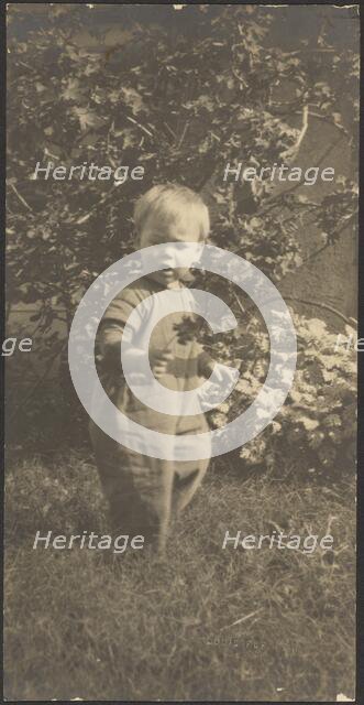 Portrait of a Child in Garden, 1907-1924. Creator: Louis Fleckenstein.