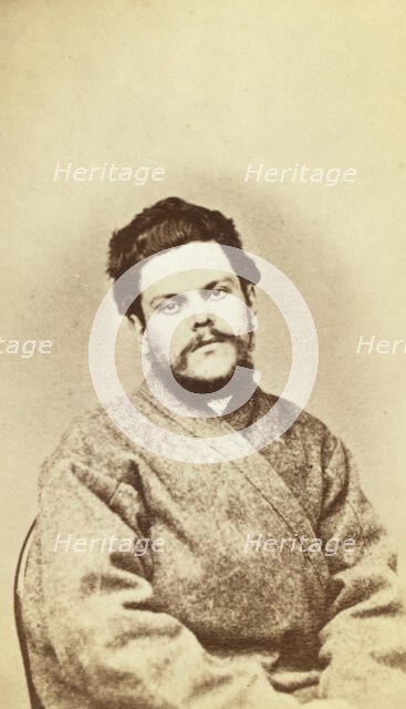 Half-length portrait of a man, dressed in convict clothing, facing front, between 1880 and 1886. Creator: Unknown.