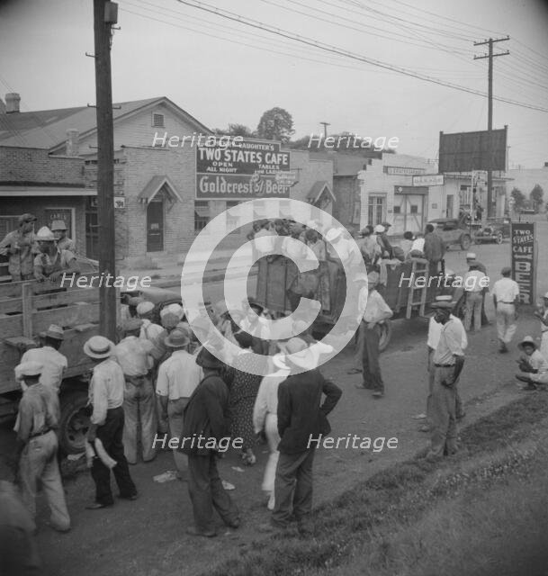 Truck loads of cotton hoers going from Memphis, Tennessee into Arkansas, 1937. Creator: Dorothea Lange.