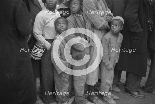Flood refugees at mealtime, Forrest City, Arkansas, 1937. Creator: Walker Evans.