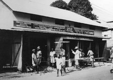 People outside an undertaker's premises, Sierra Leone, 20th century. Artist: Unknown