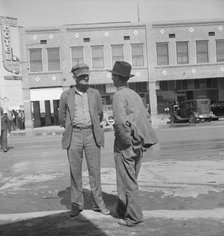 Idle pea pickers discuss prospects for work, Calipatria, Imperial Valley, CA, 1939. Creator: Dorothea Lange.