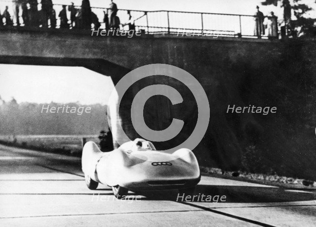 Bernd Rosemeyer driving an Auto Union, c1937-c1938. Artist: Unknown