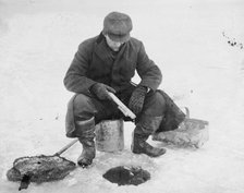 Fishing thru ice, between c1910 and c1915. Creator: Bain News Service.