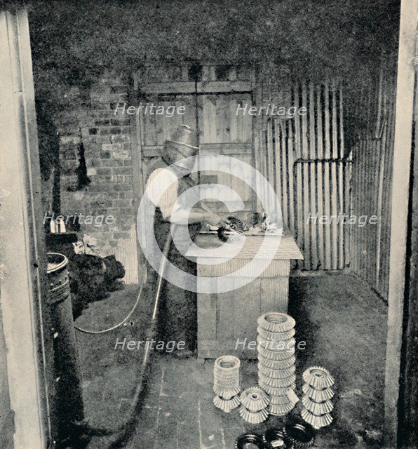 'Sand-blasting Gear Wheels', c1917. Artist: Unknown.