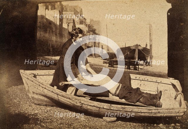 A man and a boy with bare torso in a rowing boat grounded on a beach..., c1860s. Creator: Unknown.
