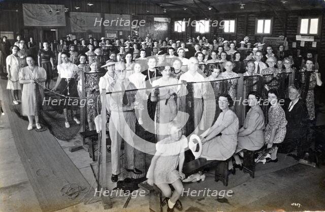 Camouflage net making, Kelvin Grove Drill Hall (now Z 10), Brisbane, 1941. Creator: Isabel Bain.