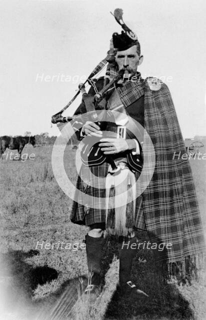 Unknown man in full Scottish kilt with bagpipes, c1900s. Creator: Robert Augustus Henry L'Estrange.