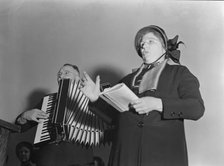 Adjutant and his wife sing, Salvation Army, San Francisco, California, 1939. Creator: Dorothea Lange.