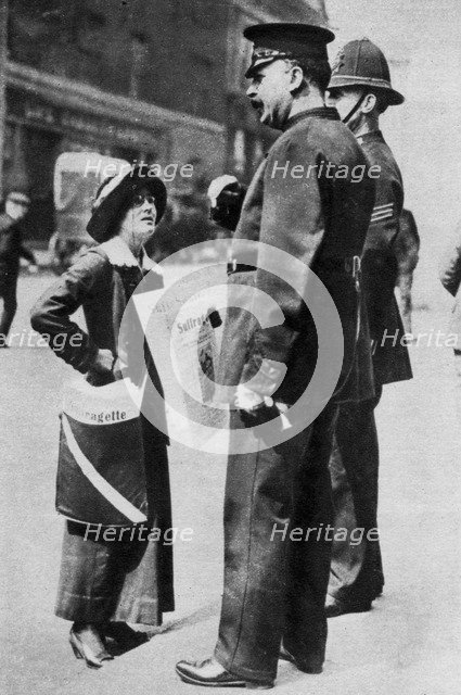 A suffragette confronting two policemen, 1913 (1937).Artist: Sport & General