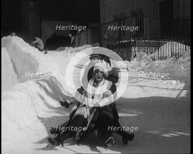 A Group of Civilians Having Fun Sledging down a Snowy Hill, 1920. Creator: British Pathe Ltd.
