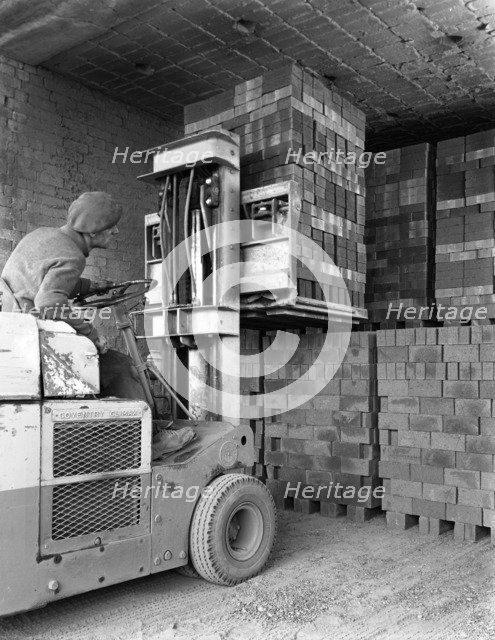 A yardsman stacking pallets of bricks, Whitwick Brickworks, Coalville, Leicestershire, 1963. Artist: Michael Walters