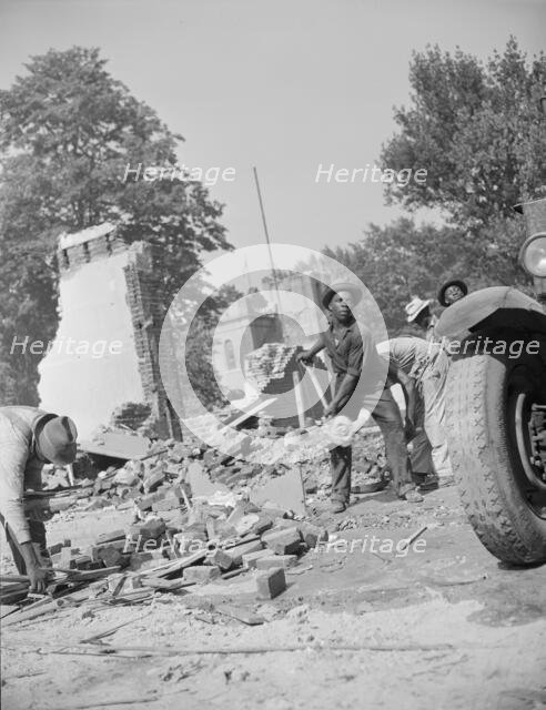 Loading debris from wrecked buildings along Independence Avenue, Washington, D.C, 1942. Creator: Gordon Parks.