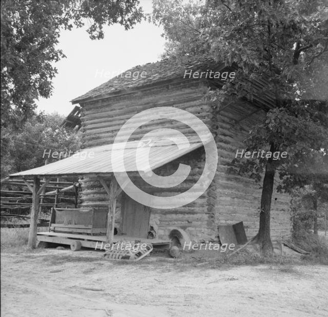 Tobacco barn with tobacco sled and vehicle..., Person County, North Carolina, 1939. Creator: Dorothea Lange.