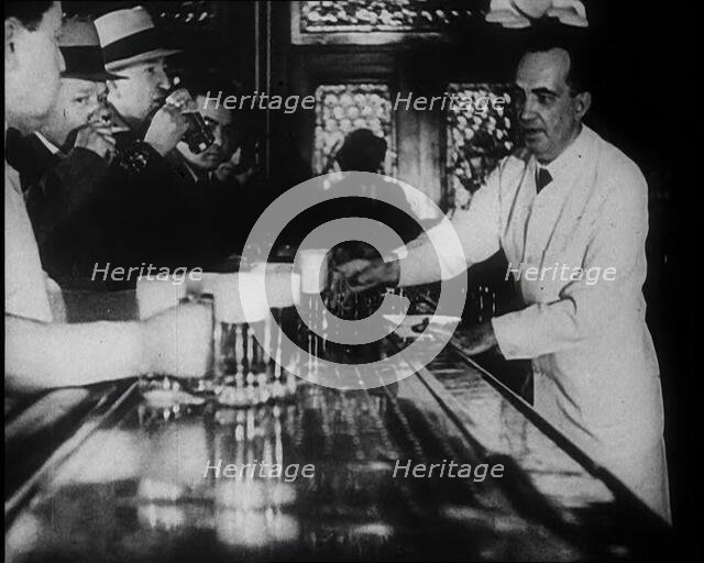 American Civilians Celebrating the End of Prohibition Drinking in a Bar, 1930s. Creator: British Pathe Ltd.