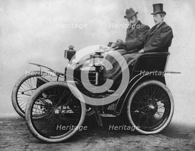 Herbert Austin at tiller of first 4 wheel Wolseley 1899. Creator: Unknown.