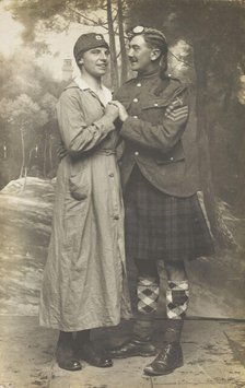 Two soldiers playing in a military concert party embrace: one is in drag and the ..., [1910-1919]. Creator: Unknown.