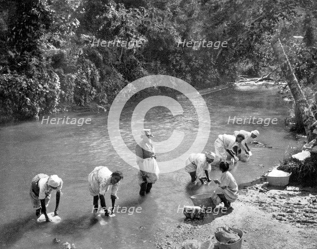 Women washing clothes in the river, Port Antonio, Jamaica, c1905. Artist: Adolphe Duperly & Son