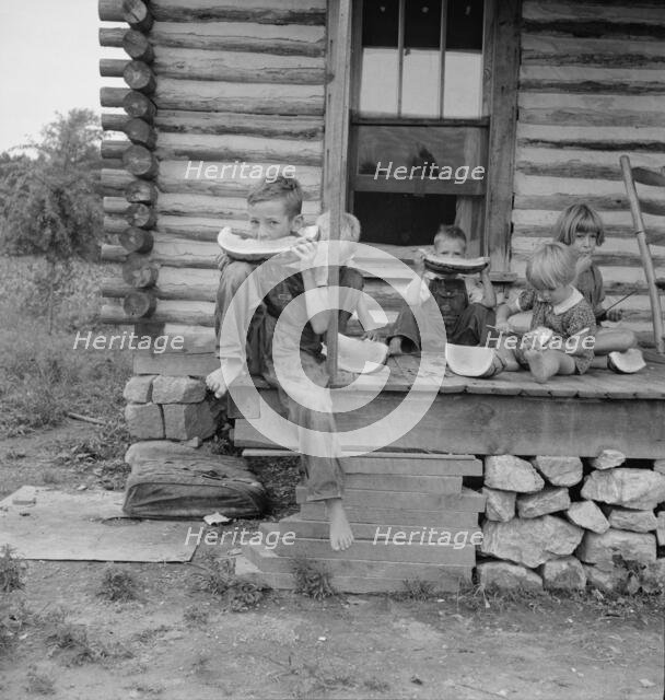Millworker's children eating watermelon on porch..., Person County, North Carolina, 1939. Creator: Dorothea Lange.