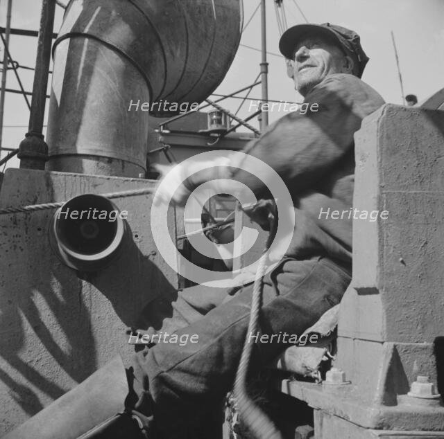 Possibly: A hoister unloading fish at Fulton fish market, New York, 1943. Creator: Gordon Parks.
