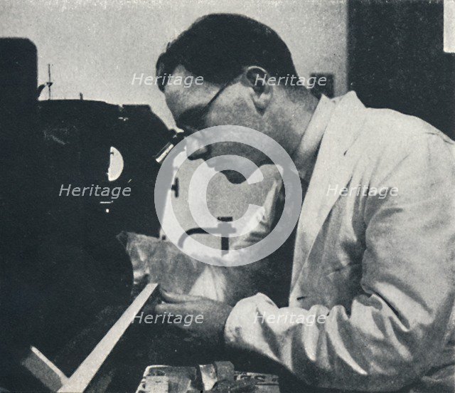 'Research worker with microscope (testing the structure of an aluminium alloy)', 1941. Artist: Cecil Beaton.