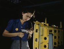 Drilling horizontal stabilizers...this woman worker at Vultee-Nashville..., Tennessee, 1943. Creator: Alfred T Palmer.