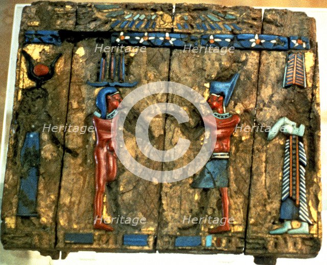 Side of a wooden box with deified human figures in polychromed stone.