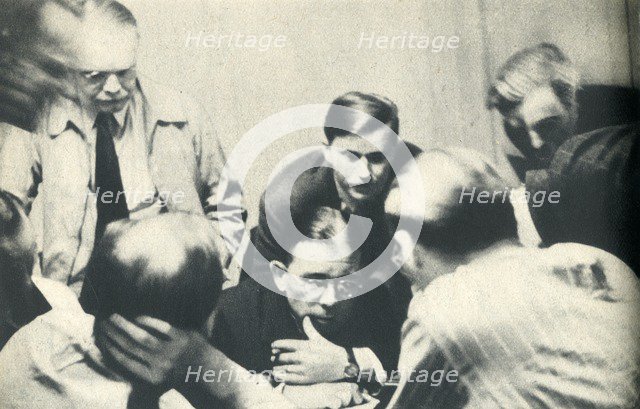 'Inside a German internment camp. Americans listen to London.', 1942. Creator: Unknown.