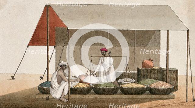 A shopkeeping weighing grains for a customer, (between 1800 and 1899?). Creator: Unknown.