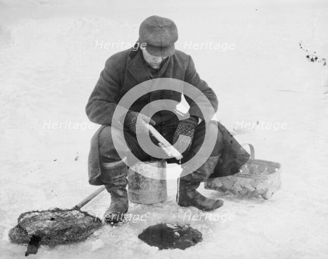 Fishing thru ice, between c1910 and c1915. Creator: Bain News Service.
