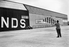 Waving the chequered flag at Brooklands, 1938 or 1939. Artist: Bill Brunell.
