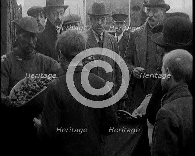 A Group of People Waiting To Receive a Measure of Coal, 1924. Creator: British Pathe Ltd.