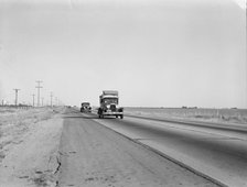 Migrants on the road, between Tulare and Fresno, California, 1939. Creator: Dorothea Lange.