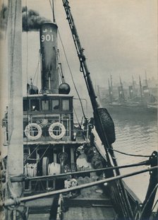 'Entering Grimsby Docks at the end of a North Sea voyage is the fishing vessel Saurian', 1937. Artist: Unknown.