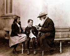 Leo Tolstoy, Russian writer, philosopher and mystic, telling his grandchildren a story, c1890-1910. Artist: Unknown