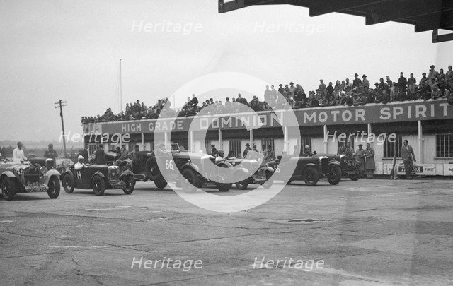 Cars at the start of a race at a JCC Meeting, Brooklands. Artist: Bill Brunell.